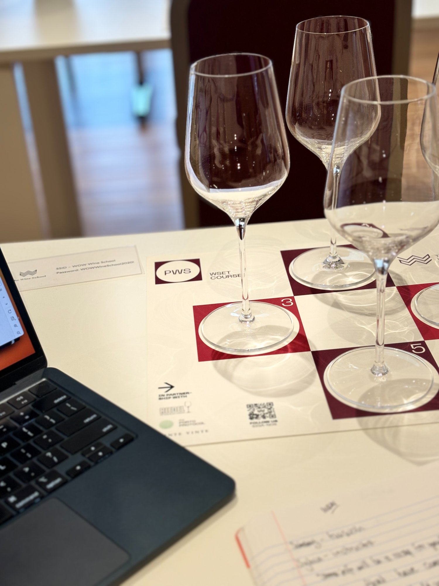 WSET wine course setup with glasses and laptop